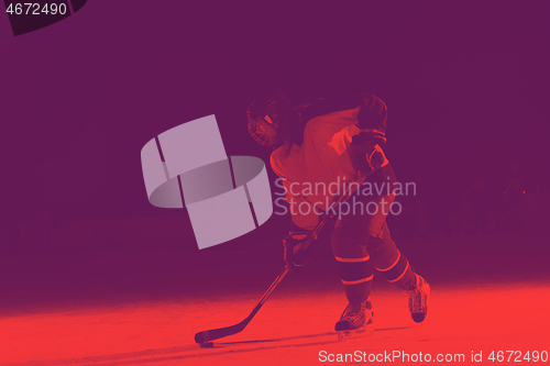 Image of teen ice hockey player in action