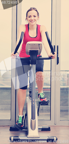 Image of womanworkout  in fitness club on running track machine 