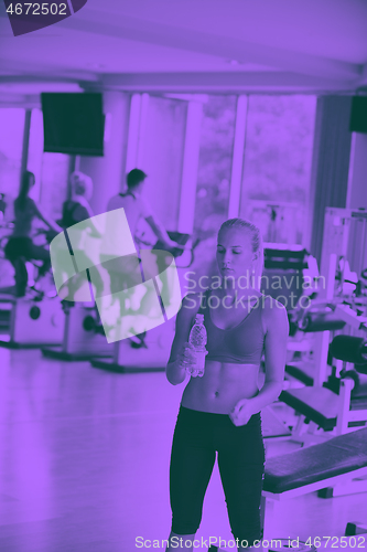 Image of woman in fitness gym drink water