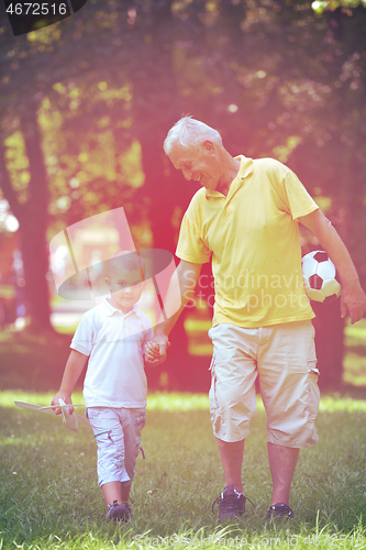 Image of happy grandfather and child in park