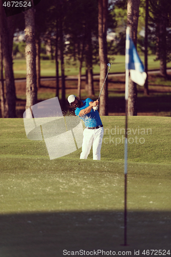 Image of pro golfer hitting a sand bunker shot