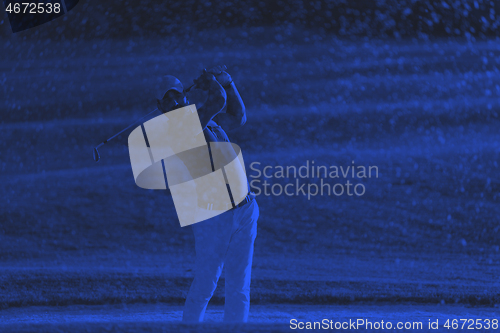 Image of golfer hitting a sand bunker shot on sunset