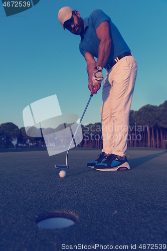 Image of golfer  hitting shot at golf course