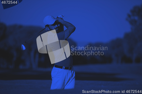 Image of pro golfer hitting a sand bunker shot