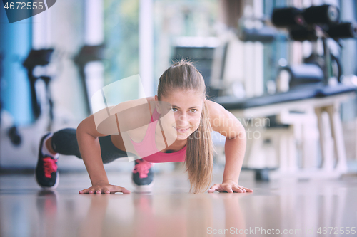 Image of warming up and doing some push ups a the gym