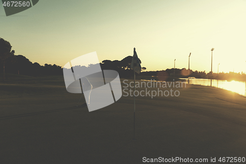 Image of golfer hitting ball to hole