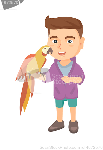 Image of Caucasian little boy holding parrot on his hand.