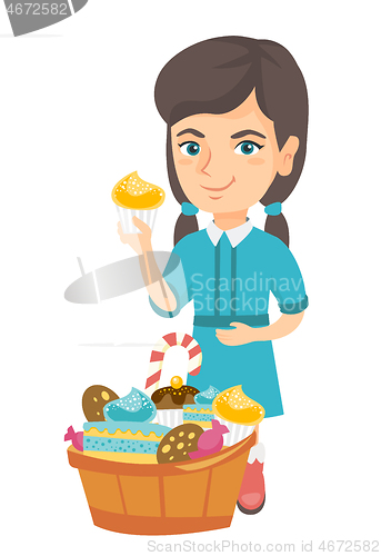 Image of Girl holding a cupcake and stroking her belly.