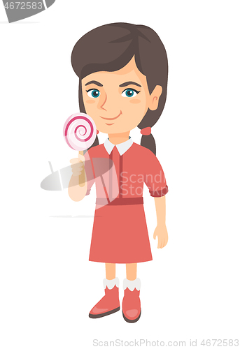 Image of Little caucasian girl holding a lollipop candy.