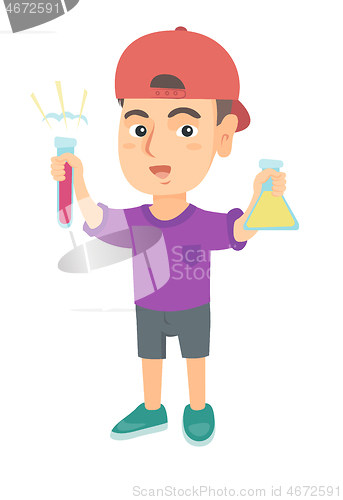 Image of Little caucasian boy holding test tube and beaker.