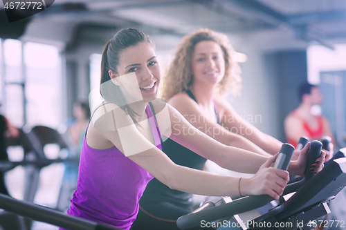 Image of Group of people running on treadmills