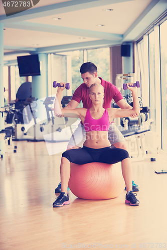 Image of young sporty woman with trainer exercise weights lifting