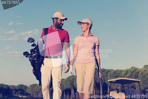 Image of couple walking on golf course