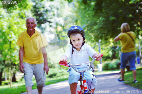 Image of happy grandfather and child in park