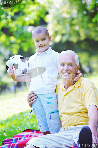 Image of happy grandfather and child in park