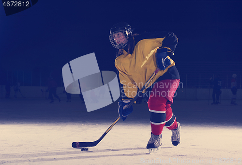 Image of teen ice hockey player in action