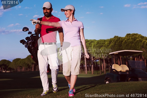 Image of couple walking on golf course