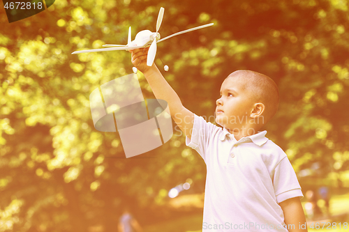 Image of boy with airpane toy