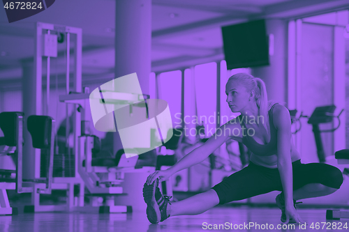 Image of woman stretching and warming up for her training at a gym