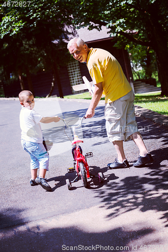 Image of grandfather and child have fun  in park