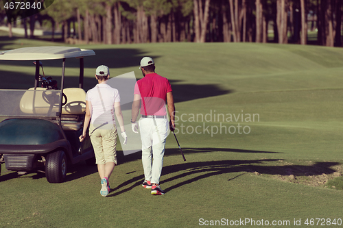 Image of couple walking on golf course