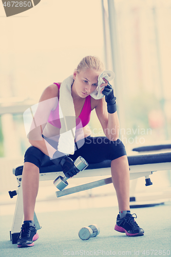 Image of young woman exercise with dumbells