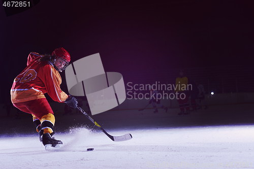 Image of teen ice hockey player in action