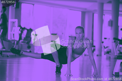 Image of woman stretching and warming up for her training at a gym