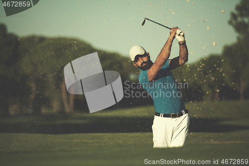 Image of pro golfer hitting a sand bunker shot