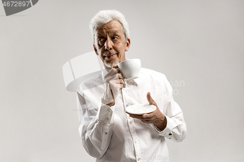 Image of old age, drink and people concept - happy senior man with cup of tea at home