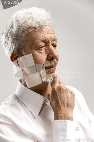 Image of The serious businessman against gray background.