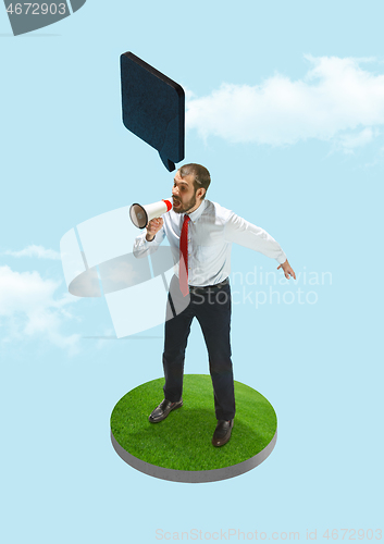 Image of Business man screaming with a megaphone on blue sky background