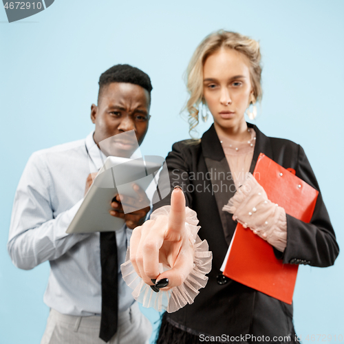 Image of Woman\'s hand with finger on blue background