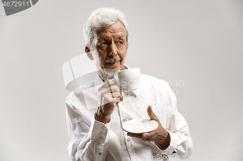 Image of old age, drink and people concept - happy senior man with cup of tea at home