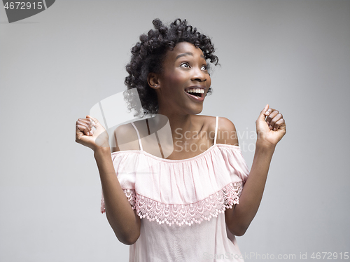 Image of Winning success woman happy ecstatic celebrating being a winner. Dynamic energetic image of female afro model