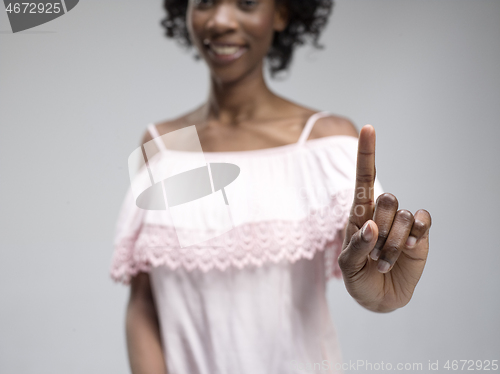 Image of Woman\'s hand with finger on blue background