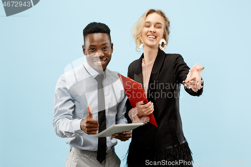 Image of Concept of partnership in business. Young man and woman standing at studio