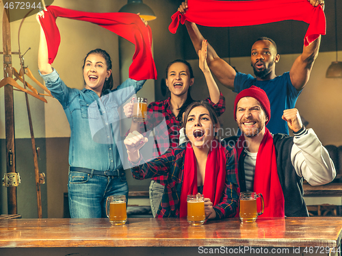 Image of Sport, people, leisure, friendship and entertainment concept - happy football fans or male friends drinking beer and celebrating victory at bar or pub