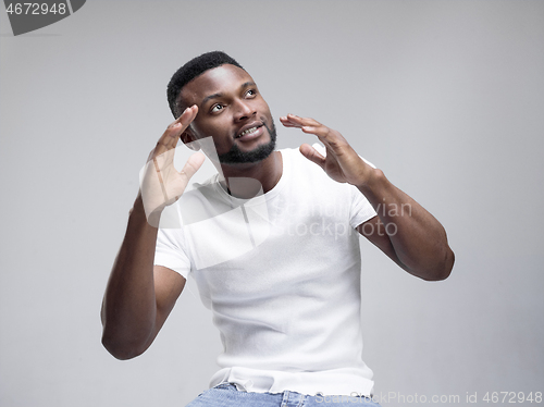 Image of African american man excited about watching tv.