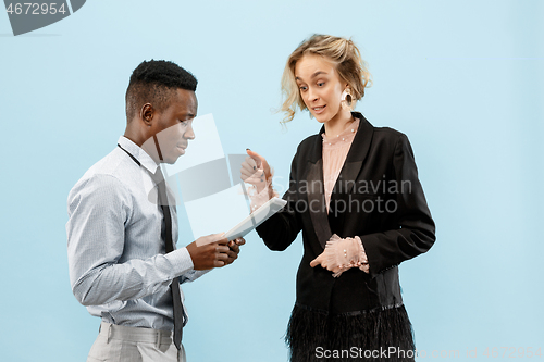 Image of Serious businesswoman and colleague in the office.