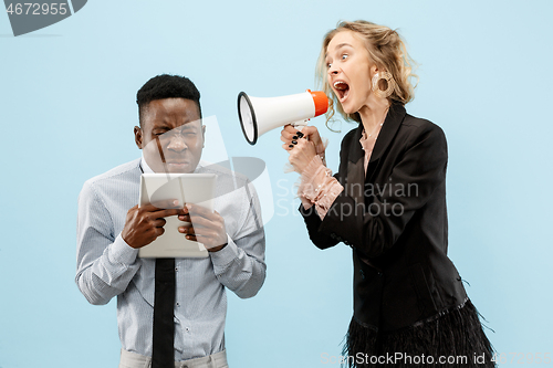 Image of angry businesswoman and colleague in the office.