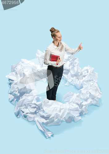 Image of Concept of a new idea. A woman and crumpled pieces of paper