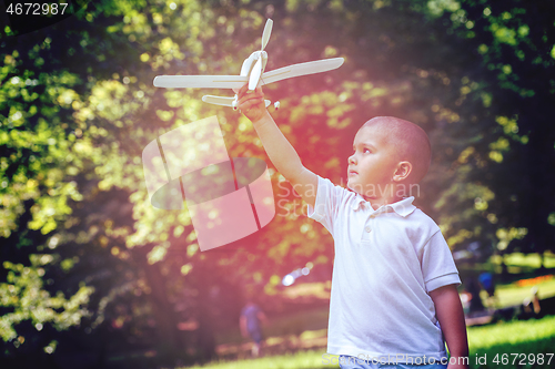 Image of boy with airpane toy