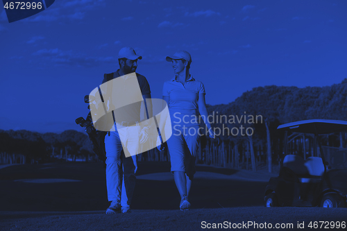 Image of couple walking on golf course