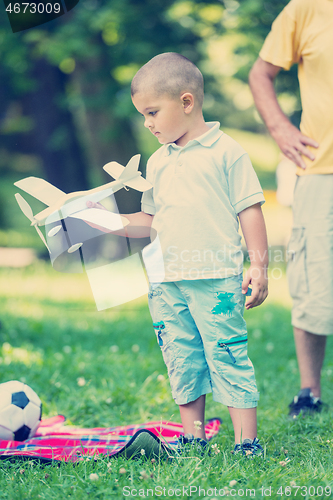 Image of grandfather and child have fun  in park