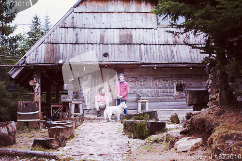 Image of frineds together in front of old wooden house