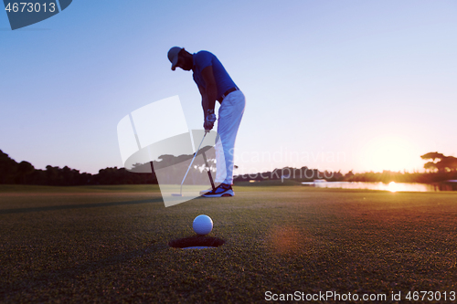 Image of golfer  hitting shot at golf course