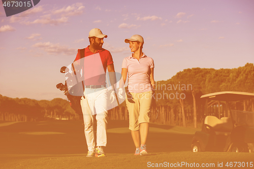 Image of couple walking on golf course