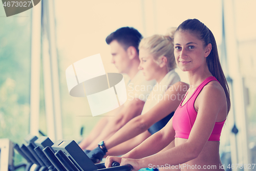 Image of friends  exercising on a treadmill at the bright modern gym