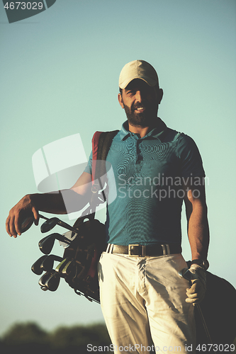 Image of golfer  portrait at golf course on sunset